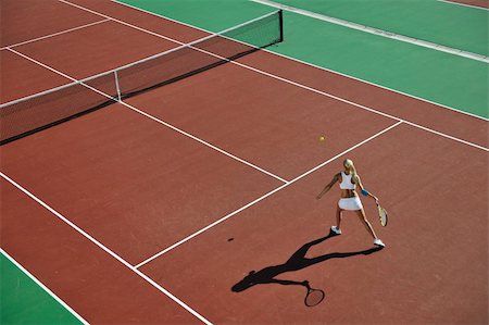 simsearch:400-06061549,k - young fit woman play tennis outdoor on orange tennis field at early morning Photographie de stock - Aubaine LD & Abonnement, Code: 400-04224351