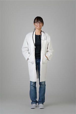 simsearch:400-04255435,k - Chinese doctor of female with friendly expression over gray studio background. Foto de stock - Super Valor sin royalties y Suscripción, Código: 400-04224418