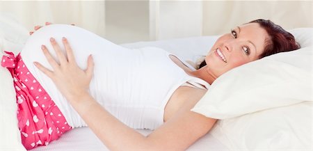 simsearch:400-04414996,k - Radiant pregnant woman resting n her bed in the bedroom at home Stock Photo - Budget Royalty-Free & Subscription, Code: 400-04224813