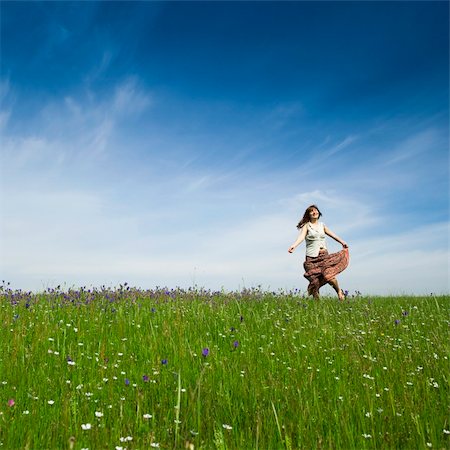Young woman dancing on a beautiful green meadow Stock Photo - Budget Royalty-Free & Subscription, Code: 400-04225066