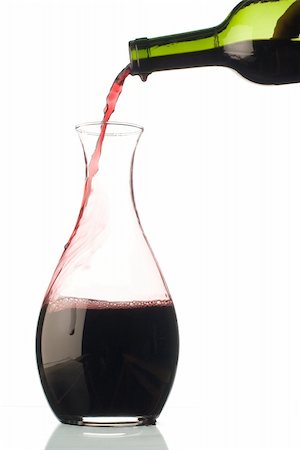 bottle of red wine pouring into a glass decanter Foto de stock - Royalty-Free Super Valor e Assinatura, Número: 400-04225463