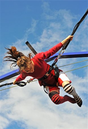 young teenager jumping on the trampoline (bungee jumping). Stock Photo - Budget Royalty-Free & Subscription, Code: 400-04225505