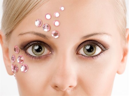 simsearch:400-04185400,k - close up portrait of woman with two big eyes looking in camera and pink stones on face Fotografie stock - Microstock e Abbonamento, Codice: 400-04225972