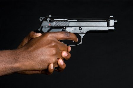 Man holding gun in hands Stock Photo - Budget Royalty-Free & Subscription, Code: 400-04226412