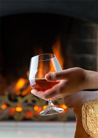 A glass of cognac on the background of a burning fireplace Stock Photo - Budget Royalty-Free & Subscription, Code: 400-04226440
