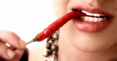simsearch:400-04575822,k - Pretty girl tasting a chilli pepper Photographie de stock - Aubaine LD & Abonnement, Code: 400-04226486