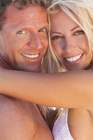simsearch:400-04310598,k - A sexy and attractive man and woman couple smiling and happy in the sunshine at the beach Stock Photo - Budget Royalty-Free & Subscription, Code: 400-04226829