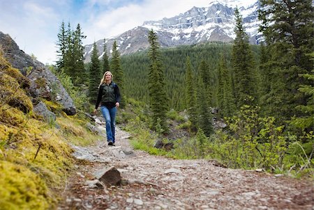 A happy woman walking on a path on a mountain hike in Banff National Park Stock Photo - Budget Royalty-Free & Subscription, Code: 400-04227066