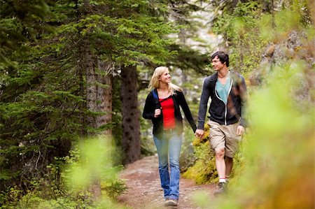 A happy couple looking at eachother and walking in the forest holding hands Stock Photo - Budget Royalty-Free & Subscription, Code: 400-04227063