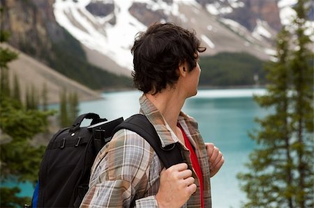 A young man looking out on a beautiful lake and mountain landscape Stock Photo - Budget Royalty-Free & Subscription, Code: 400-04227078