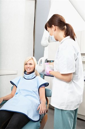 Female dental assistant taking oral x-ray of a patient Stock Photo - Budget Royalty-Free & Subscription, Code: 400-04227111