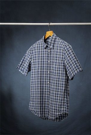 A short sleeved men's plaid casual summer shirt hanging on a hanger. Stock Photo - Budget Royalty-Free & Subscription, Code: 400-04227344