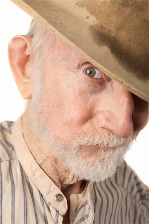 simsearch:400-04278950,k - Grungy senior cowboy with a sweat-stained hat Fotografie stock - Microstock e Abbonamento, Codice: 400-04227844