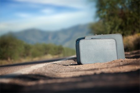 Suitcases by the side of a desert road Stock Photo - Budget Royalty-Free & Subscription, Code: 400-04227854