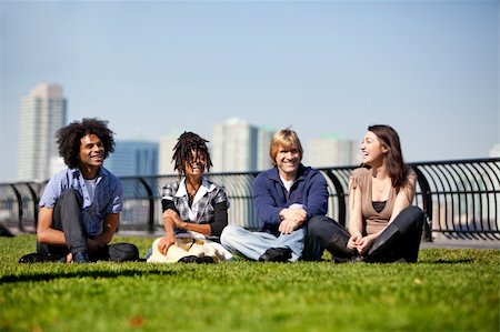 A group of friends in a city park talking and laughing Stock Photo - Budget Royalty-Free & Subscription, Code: 400-04227983