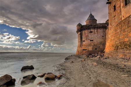 View on the atlantic ocean and church from the beach near Mont Saint-Michel abbey in Brittany, France Stock Photo - Budget Royalty-Free & Subscription, Code: 400-04228173