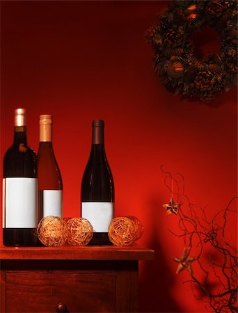 WIne Bottles in festive setting with decorations and wreath Fotografie stock - Microstock e Abbonamento, Codice: 400-04229094