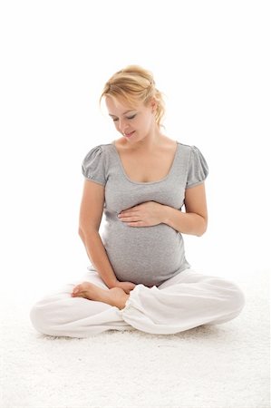 Beautiful pregnant woman  touching her lovely belly - isolated Stock Photo - Budget Royalty-Free & Subscription, Code: 400-04229170