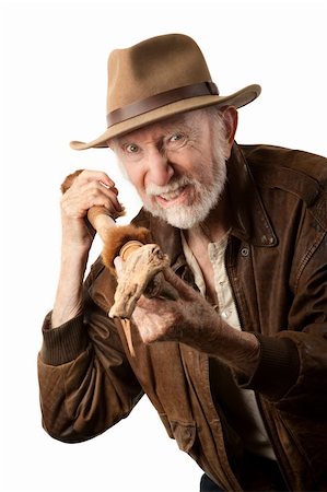 surprised old man with a beard - Adventurer or archaeologist in brown leather jacket defending himself with abcient weapon Stock Photo - Budget Royalty-Free & Subscription, Code: 400-04229282