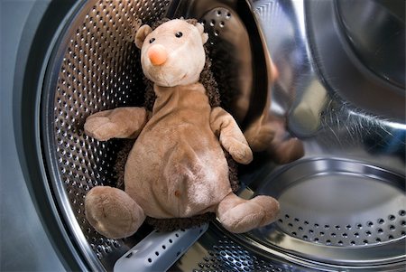 A toy hedgehog sitting inside the washing machine. Stock Photo - Budget Royalty-Free & Subscription, Code: 400-04229313