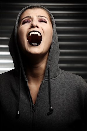portrait screaming girl - A screaming hooded vampire over dark background Stock Photo - Budget Royalty-Free & Subscription, Code: 400-04220402