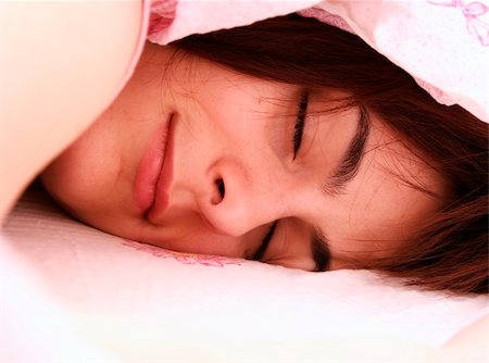 Beautiful young woman sleeping on bed in her bedroom at home in the morning. Stock Photo - Budget Royalty-Free & Subscription, Code: 400-04220462