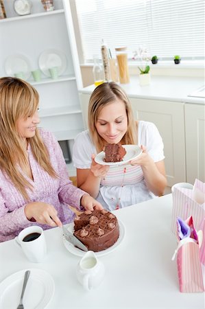simsearch:400-04212407,k - Delighted female friends eating a chocolate cake in the kitchen at home Stock Photo - Budget Royalty-Free & Subscription, Code: 400-04220776
