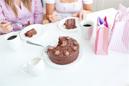 simsearch:400-04212407,k - Close-up of caucasian female friends eating a chocolate cake in the kitchen at home Stock Photo - Budget Royalty-Free & Subscription, Code: 400-04220777