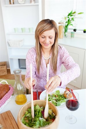 simsearch:400-04212835,k - Radiant woman eating salad in the kitchen at home Photographie de stock - Aubaine LD & Abonnement, Code: 400-04220771