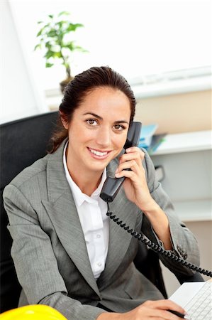 female workers in hard hats and tools - Busy hispanic female architect using her laptop while talking on phone in her office Stock Photo - Budget Royalty-Free & Subscription, Code: 400-04220849