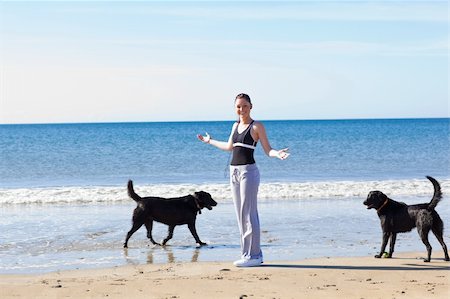 Young sporty woman surrounded by two dogs Stock Photo - Budget Royalty-Free & Subscription, Code: 400-04220955