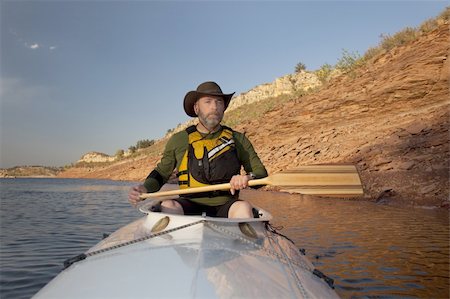 simsearch:400-07546780,k - mature adult paddler in an expedition decked canoe on calm mountain lake (Horsetooth Reservoir near Fort Collins, Colorado) Stock Photo - Budget Royalty-Free & Subscription, Code: 400-04221268