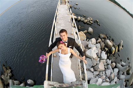 A portrait of a young beautiful married couple who are posing by the sea Stock Photo - Budget Royalty-Free & Subscription, Code: 400-04221888