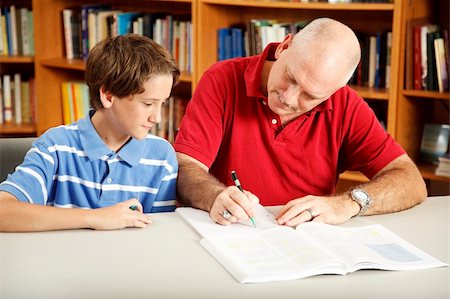 simsearch:400-04118366,k - Father helps his son with homework, in the library. Photographie de stock - Aubaine LD & Abonnement, Code: 400-04222528