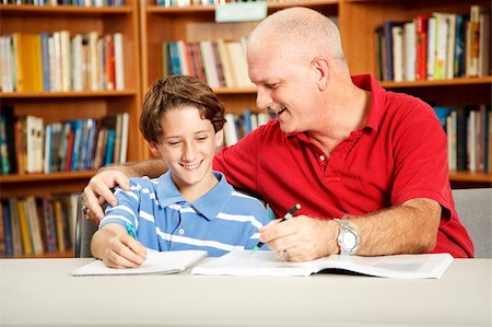 simsearch:400-04118366,k - Father helping with his son's homework, in the school library. Photographie de stock - Aubaine LD & Abonnement, Code: 400-04222530