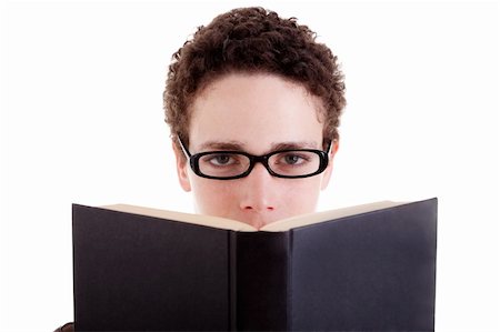 Young man with glasses, peering over an open book, isolated on white, studio shot Stock Photo - Budget Royalty-Free & Subscription, Code: 400-04222725
