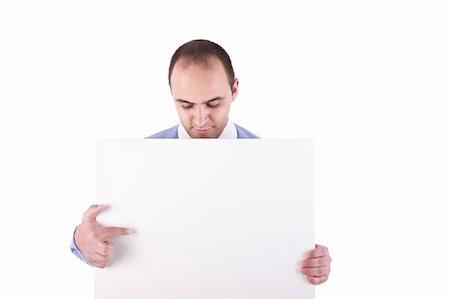 employee hold a sign - Young businessman holding a white board and pointing, looking down Stock Photo - Budget Royalty-Free & Subscription, Code: 400-04222736