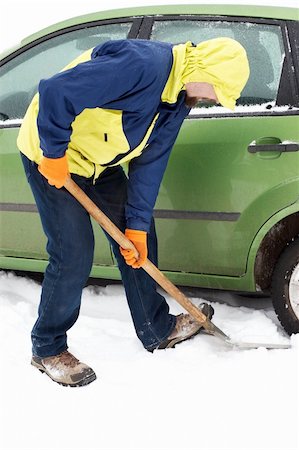 parked snow - Man digging car wheels from the snow Stock Photo - Budget Royalty-Free & Subscription, Code: 400-04222891