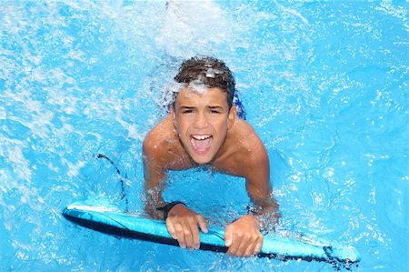 simsearch:400-04731600,k - boy teenager surfboard splashing blue water happy in sea pool Stock Photo - Budget Royalty-Free & Subscription, Code: 400-04222928