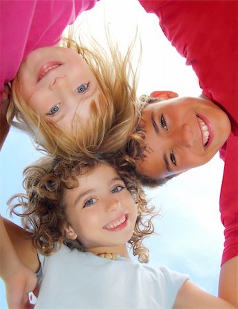 simsearch:400-06747489,k - Below view of happy three children embracing hug each other smiling camera Stock Photo - Budget Royalty-Free & Subscription, Code: 400-04222930