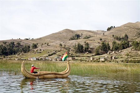 puno - The Uros, an indigenous people predating the Incas, live on Lake Titicaca upon floating islands fashioned from this plant. The Uros also use the Totora plant to make boats (balsas) of the bundled dried plant reeds. Photographie de stock - Aubaine LD & Abonnement, Code: 400-04223175