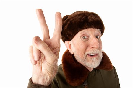 simsearch:400-04227846,k - Senior Russian Man in Fur Cap and Jacket Making Peace Sign Fotografie stock - Microstock e Abbonamento, Codice: 400-04223739