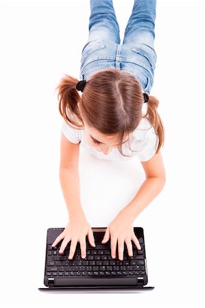 simsearch:400-04129482,k - Top view of a little girl lying on floor working with a laptop Photographie de stock - Aubaine LD & Abonnement, Code: 400-04234036