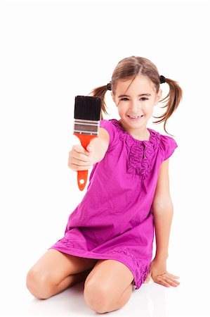 Happy girl sitting on floor holding a paint-brush Stock Photo - Budget Royalty-Free & Subscription, Code: 400-04234030