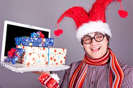 Funny men in christmas cap with gift boxes and notebook. Studio shot. Stock Photo - Budget Royalty-Free & Subscription, Code: 400-04234150
