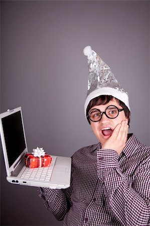 Funny men in christmas cap with gift box and notebook. Studio shot. Stock Photo - Budget Royalty-Free & Subscription, Code: 400-04234152
