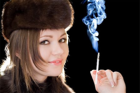 simsearch:400-04631926,k - Portrait of the smiling young lady with a cigarette Stock Photo - Budget Royalty-Free & Subscription, Code: 400-04234202