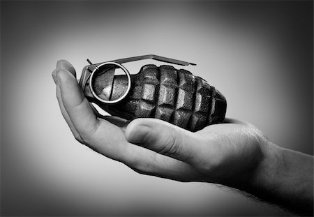 Man holding a hand grenade on his hand. Fotografie stock - Microstock e Abbonamento, Codice: 400-04234861