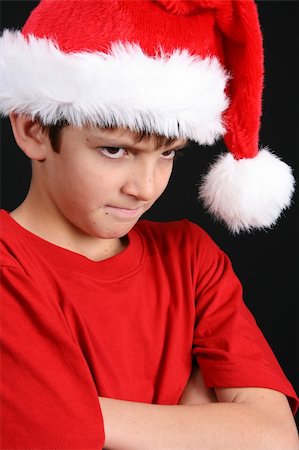 simsearch:400-05284316,k - Young boy wearing a red shirt and christmas hat Stockbilder - Microstock & Abonnement, Bildnummer: 400-04235110