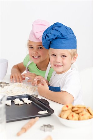 Adorable siblings kneading together a dough in the kitchen to make cookies Stock Photo - Budget Royalty-Free & Subscription, Code: 400-04235218